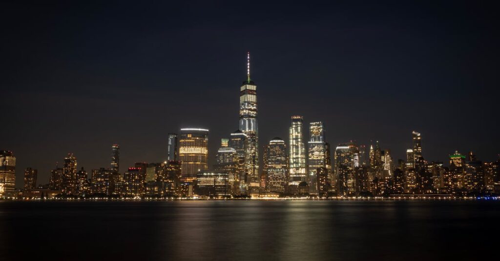 pexels-photo-3359250-3359250 Breathtaking view of New York City's illuminated skyline reflecting on the waterfront at night.