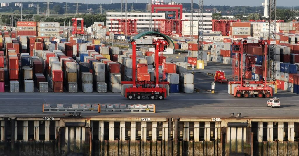 pexels-photo-9211513-9211513 Aerial shot of cargo containers and cranes at Bremerhaven port, Germany.